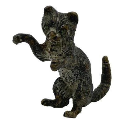 Antique bronze cat in miniature. Sweet little antique cold painted bronze cat which can be displayed in 3 poses: sat upright with front paws raised, on all four paws or on its side in 'rub my tummy' pose. Some wear to the paint. Main photo of cat in upright pose with the face facing camera and front paws raised. The tail is in the lower right hand side of photo with the tip of it pointing straight up towards the top right of photo.
