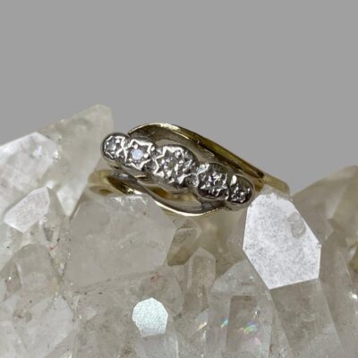 Close up of the ring front focusing on the diamonds to the front and split style band.