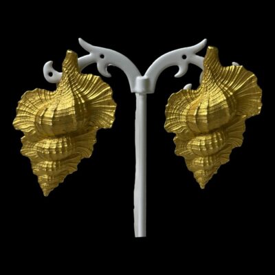 Main photo of earrings displayed on a white display stand and against a black background. The earrings are like small conch shells that have been sliced in half and dipped into liquid gold. Very striking pair of statement earrings.