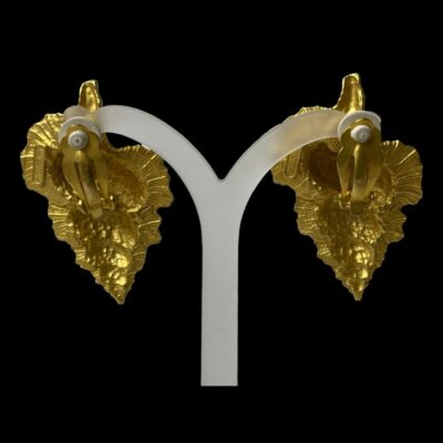 Photo of earrings shown displayed on a white stand and shown from the back.