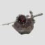 Main photo of brooch displayed on top of a small lump of natural amethyst of a lilac colour which contrasts to the darker purple colour of the amethyst on the brooch. The sword hilt is to the right.