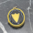 Main photo of locket seen displayed on a piece of black marble with white line inclusions.