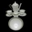 Main photo of whole set displayed together against a black background which enhances the colouring of the set which is mostly white with pale green and silver accents to the rims. The coffee pot is in the background with the 2 cups and saucers to either side. The milk/cream jug is next in front of the cups then the sugar bowl is right at the front.