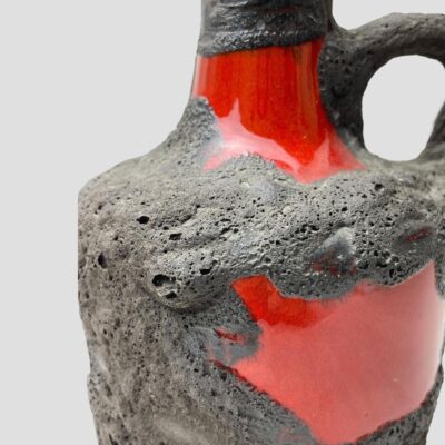 Close up photo of the red gloss areas on the main picture showing the effect of the lave overlay. There are tiny bubbles in the lava which gives an other worldly dimension.