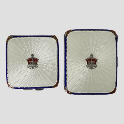Photo of both items displayed side by side. The compact which is slightly smaller is on the left and the cigrette case is on the eright.