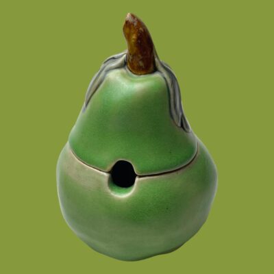 Photo of pot with lid in place and seen with the gap for spoon in the centre foreground.