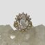 Main photo of the ring displayed on top of some quartz crystal with the ring front facing forward. The diamonds are shining beautifully.