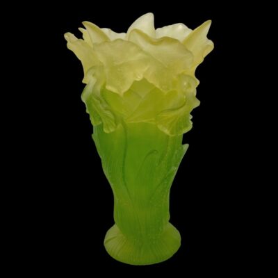 Photo of vase from an eye level with one flower head to the left ad one to the right.