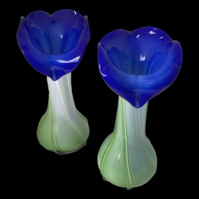 Photo of vases shown side by side with right hand one slightly forward. The photo is taken looking down diagonally to show the vibrant blue tops of the flower heads.