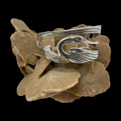 Photo of cuff displayed on top of a sand rose with just one crane in view.