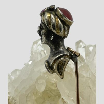 Photo of pin showing just the head part with the lady's head in profile and looking left. The carnelian stone to the back of the turban hat is visible in this photo.