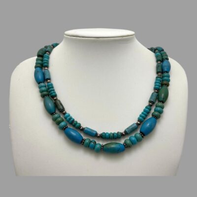 Photo of necklace displayed on a stand and seen looking straight on from the front.