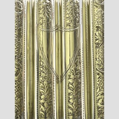 Close up photo of the cartouche area of the case also showing the elaborate decoration on the silver.