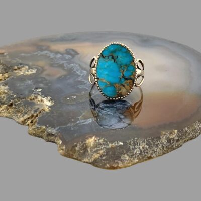 Main photo of the ring displayed on top of a slice of natural agate and shown with ring front facing forward.
