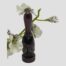 Main photo showing Fukurokuju deity forward facing and from a very slight height. He has both hands inside opposing arms of his haori kimono and has a lovely serene and calming face. His elongated head is almost the size of the rest of his body. There is a spray of small white orchids behind the okimono giving an extra Oriental feel!