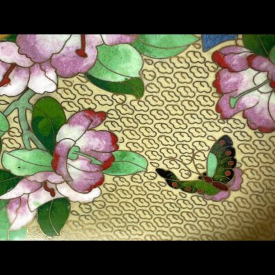 Close up photo of the decoration on the inside of bowl. There are pink peonies with dark and light green leaves and butterfly with green and pink wings.