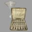 Main photo showing the forks inside the fitted case with the lid open upright and leaning against a cocktail glass.
