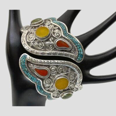 Photo of bangle displayed on a dark colour display hand with the bangle placed across the palm and the opening area shown slightly open.