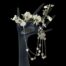 Main photo of necklace displayed draped on a dark coloured display hand with the majority of the cubes hanging on the right. There is a small spray of white orchids across the fingers to the top.