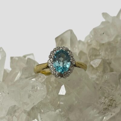 Photo of ring displayed on top of some natural quartz crystal with the ring front forward facing.