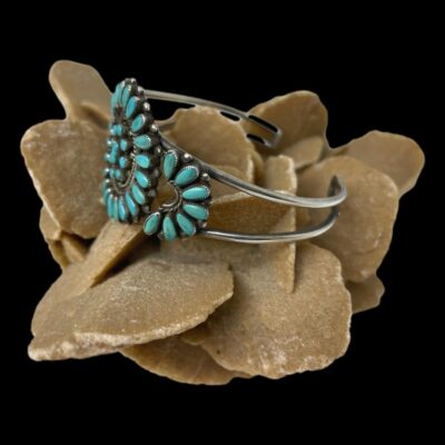 Photo of bracelet displayed on top of a rock of desert sand rose with the front of bracelet facing left.