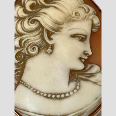 Close up photo of the cameo carving and the fine features of the beautiful dreamy lady.