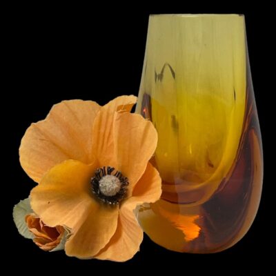 Photo of vase seen from a diagonally sideways angle with one wide side facing towards the left. The orange poppy is still to the left.