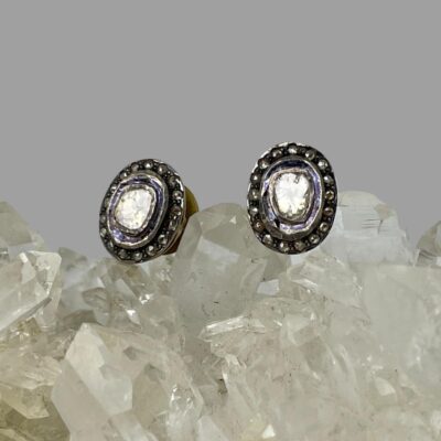 Photo of earrings displayed on top of the quartz crystal and shown forward facing.