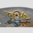 Main photo of brooch displayed on top of a slice of natural agate with the brooch front forward facing. The horseshoe is open end down as it should be and the single sapphire is to the centre. (Better described in photo 2)