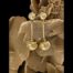 Main photo of the earrings displayed side by side vertically on a cluster of desert sand rose. The small ball sits at the end of the earring posts with a short bar attached and large ball at the end of the bar. They are simple but very elegant earrings.