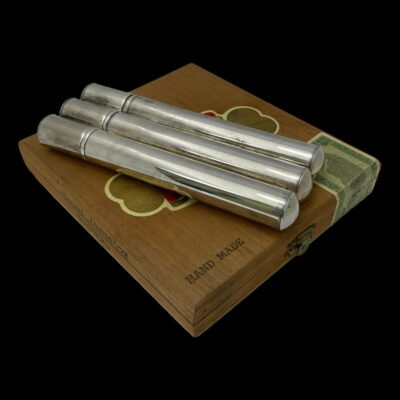 Photo of cigar case displayed on top of the old wooden cigar case with the lid end in the top left corner.