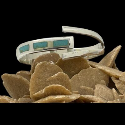 Secondary photo of bracelet displayed on top of a rock of desert sand rose with the front of bracelet forward facing.
