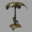 Main photo of the candlestick from an eye level with the stag facing to the left. The snake can be seen coiled to the palm trees trunk behind the stag and also facing the same direction. The fan palm fronds appear like an umbrella sheltering the 2 creatures.