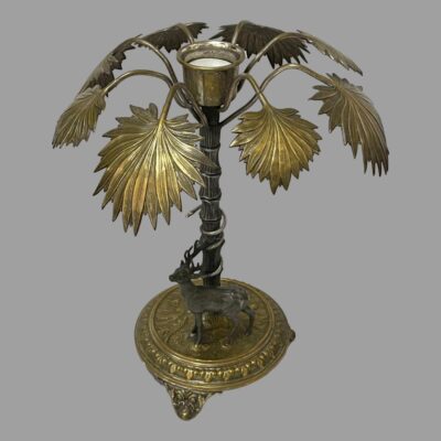 Secondary photo taken from a raised angle looking diagonally down to the top of the palm tree to show the silver plate pot for the candle. There is a tealight in the pot at the centre of the tree top.
