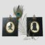 Main photo of the 2 portraits displayed side by side with a single peacock feather between the 2. Both silhouette profiles are facing to the right.