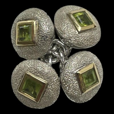 Photo of the cufflinks in close up. They are crossed over each other and shown with both ends facing up.